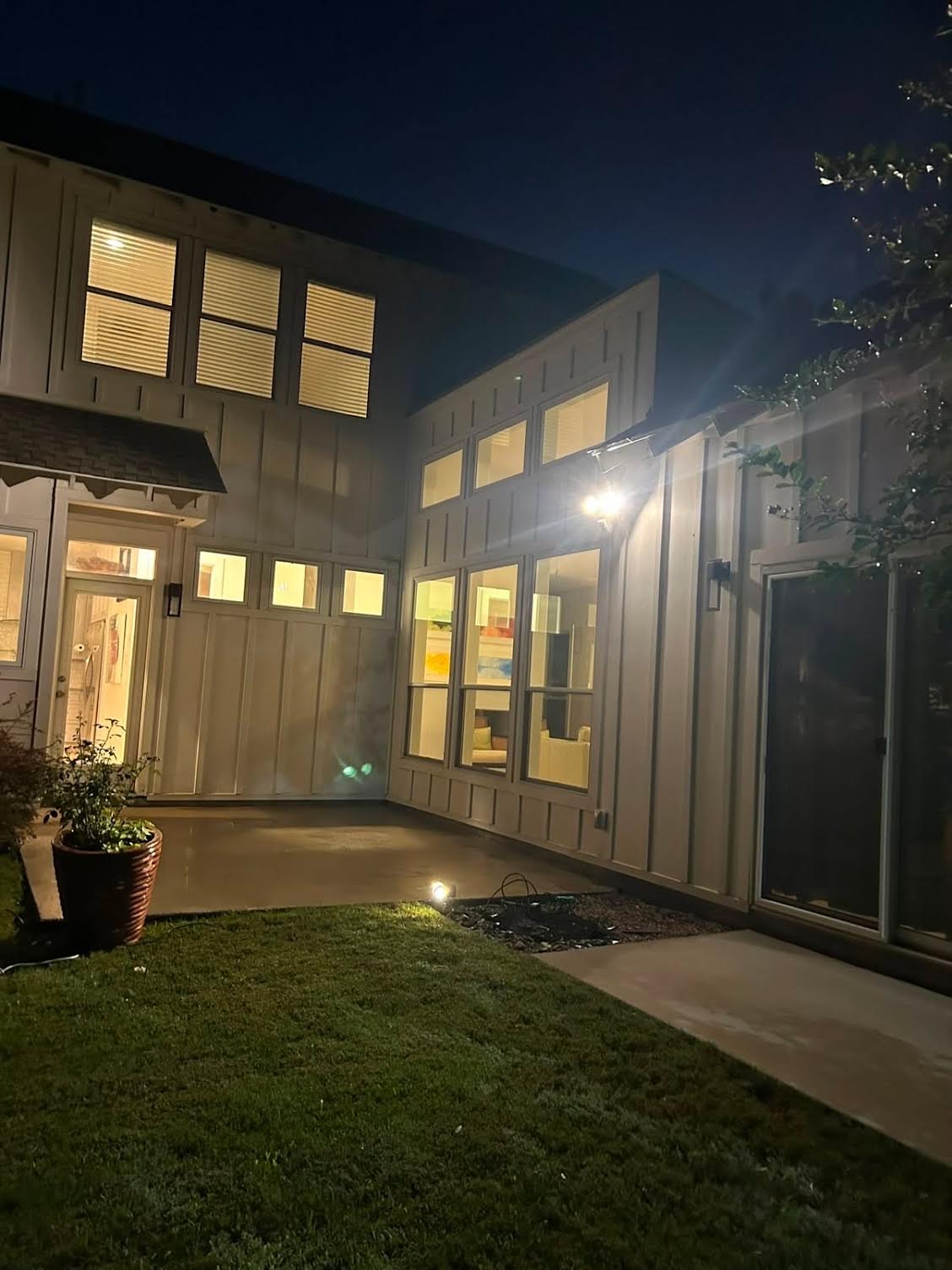 Evening landscape lighting on a courtyard lawn and mulched bed